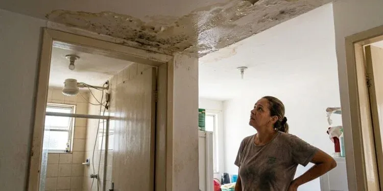 Resident_inspecting_ceiling_wate…_20261006092921-1-750x375.webp